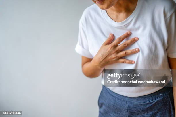 woman suffering from chest pain heart attack. healthcare and medical concept. - borstkas stockfoto's en -beelden