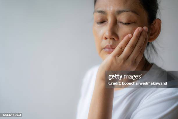 woman suffering from toothache, tooth decay or sensitivity - rotten teeth from not brushing fotografías e imágenes de stock
