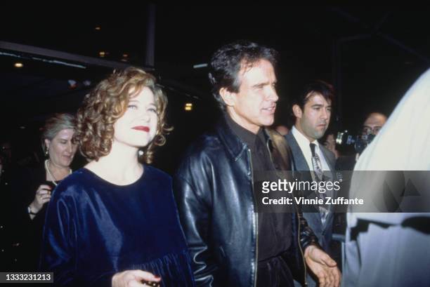 American actress Annette Bening, wearing a navy blue crew neck outfit, and American actor Warren Beatty attend the Beverly Hills premiere of 'Bugsy',...