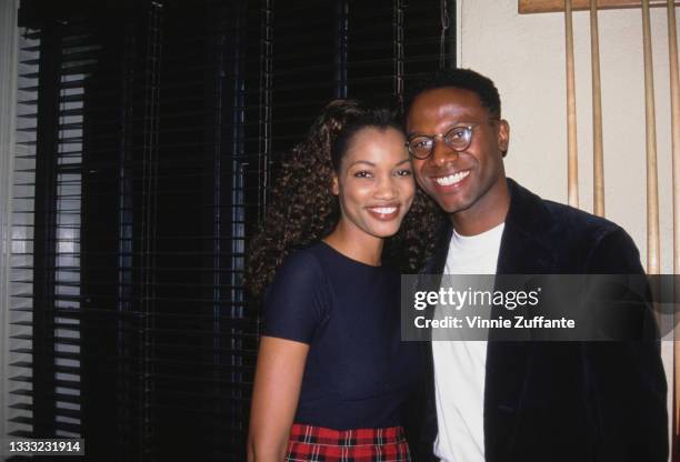 Haitian-born American actress and fashion model Garcelle Beauvais, wearing a tartan miniskirt and a navy blue t-shirt, and her husband, producer...