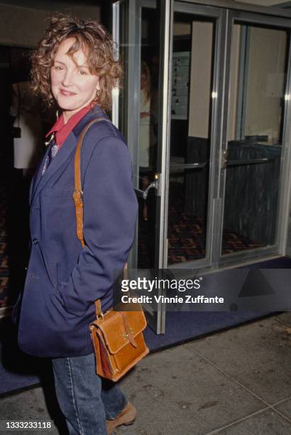 Bonnie Bedelia, wearing a blue blazer over a red shirt, with a tan leather shoulder bag, attends the premiere of 'Eating' held at the Fine Arts...