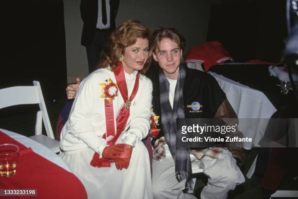 British actress Stephanie Beacham, wearing a white outfit with a red sash, and American child actor Jonathan Brandis attend the 62nd Annual Hollywood...