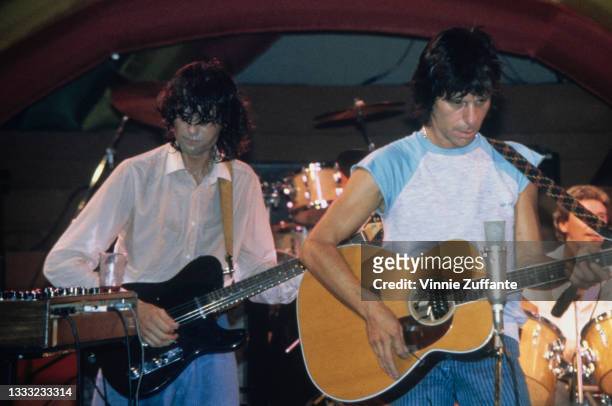 British guitarist and songwriter Jimmy Page and British guitarist and songwriter Jeff Beck, wearing a white cap sleeve t-shirt, with blue detail on...