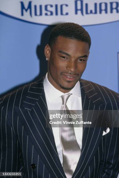 American model and actor Tyson Beckford, wearing a pinstripe suit jacket with a white shirt and silk tie, attends the 8th Annual Billboard Music...