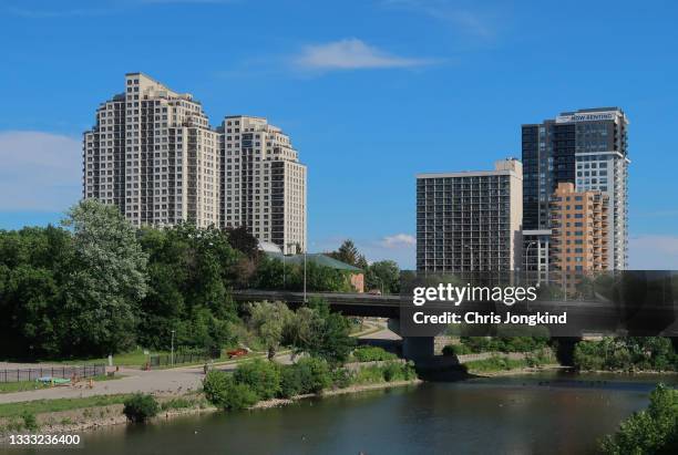 residential buildings over bridge and river in urban cityscape - london ontario stockfoto's en -beelden