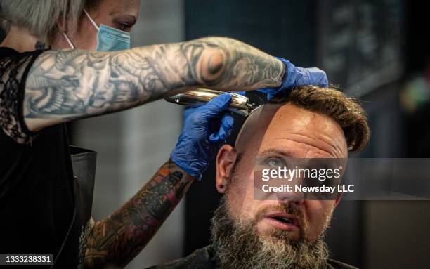 Hair dresser Tera Degregoris working on a Faux Hawk on Jesse Roberts at Noble Savage Barber Shop in Bay Shore, Mew York om July 10, 2021. The cut is...
