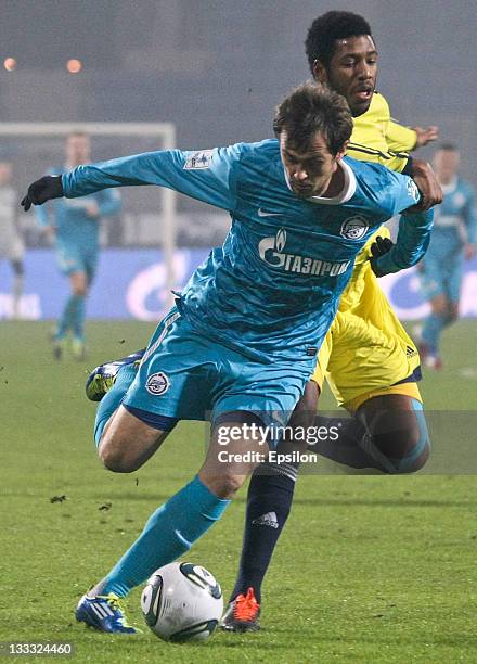 Danko Lazovic of FC Zenit St. Petersburg vies for the ball with Jucilei of FC Anzhi Makhachkala during the Russian Football League Championship match...