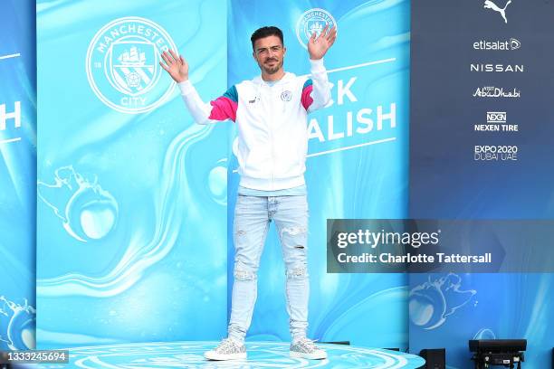 Jack Grealish of Manchester City waves to fans during his unveiling at Etihad Stadium on August 09, 2021 in Manchester, England.