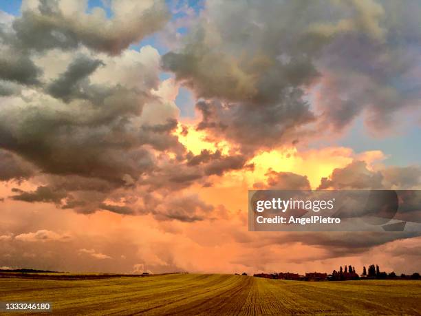 stormy sunset on the plane - tormenta stock pictures, royalty-free photos & images
