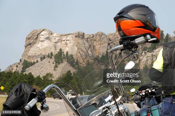 Bikers stop to take in Mt. Rushmore on August 09, 2021 near Keystone, South Dakota. Every August hundreds of thousands of motorcycling enthusiasts...