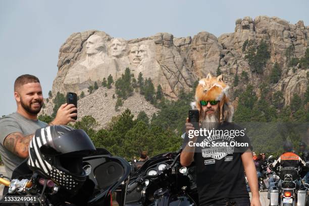 Bikers stop to take in Mt. Rushmore on August 09, 2021 near Keystone, South Dakota. Every August hundreds of thousands of motorcycling enthusiasts...