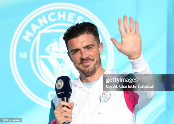 Jack Grealish of Manchester City waves to fans before leaving as he unveiled to fans at Etihad Stadium on August 09, 2021 in Manchester, England.