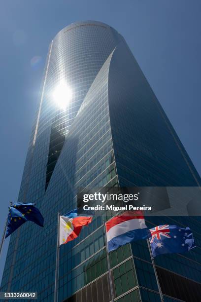 International flags wave right in front of Torre de Cristal , one of the most premium office buildings in the country, located in the CTBA business...