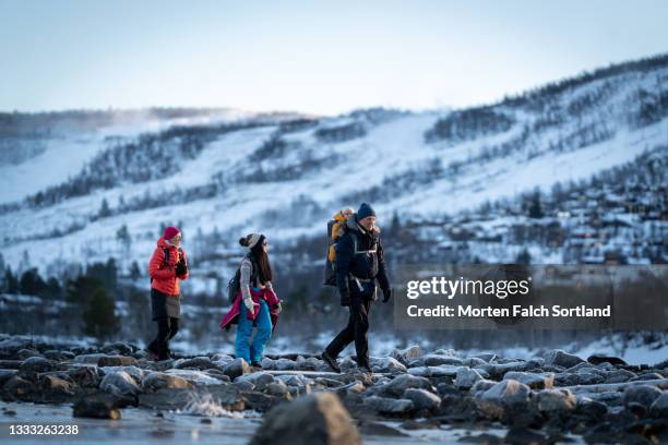 adventurous family taking a hike in the snow - grandfather child snow winter stock pictures, royalty-free photos & images