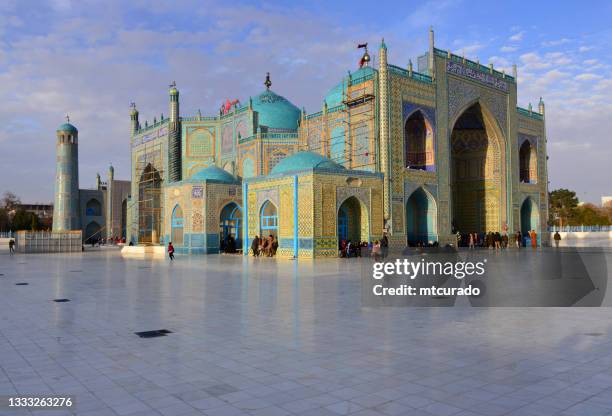 shrine of ali (hazrat ali mazar) with pilgrims resting, mazar-i-sharif, balkh province - shi'ite islam stock pictures, royalty-free photos & images