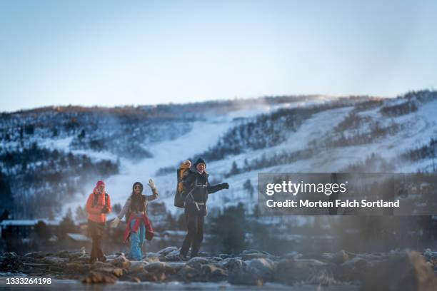 adventurous family taking a hike in the snow - family trip in laws stock pictures, royalty-free photos & images