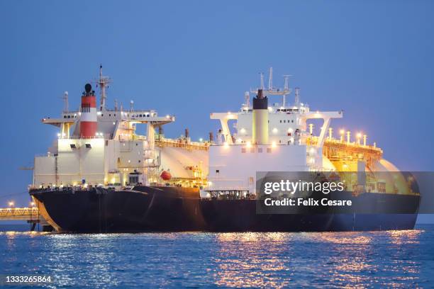 a liquified natural gas tanker supplying gas to a floating storage unit ship (lng fsu) - tanker fotografías e imágenes de stock