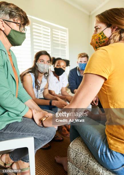 people in masks talking during a support group meeting at a friend's home - prayer meeting stock pictures, royalty-free photos & images