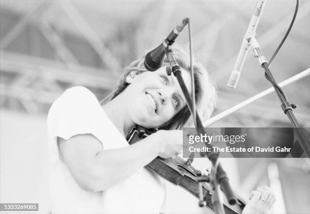 American bluegrass and country singer songwriter, bluegrass fiddle virtuouso, and musician Alison Krauss performs in August, 1997 at the Newport Folk...