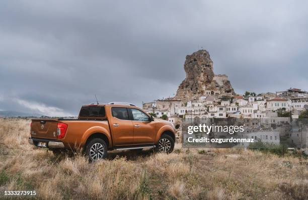 nissan np300 navara stopped on the hill near ortahisar castle in cappadocia - nissan stock pictures, royalty-free photos & images