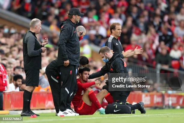 Curtis Jones of Liverpool looks dejected as he receives medical treatment for an injury before being substituted during the Pre-Season Friendly match...