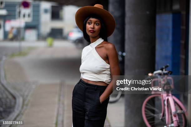 Guest is seen wearing brown hat outside outside Day Birger et Mikkelsen on August 09, 2021 in Copenhagen, Denmark.