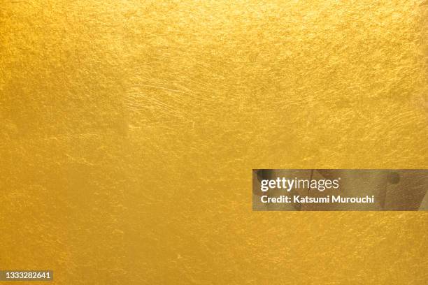 metalic gold foil paper texture background - carta stagnola foto e immagini stock
