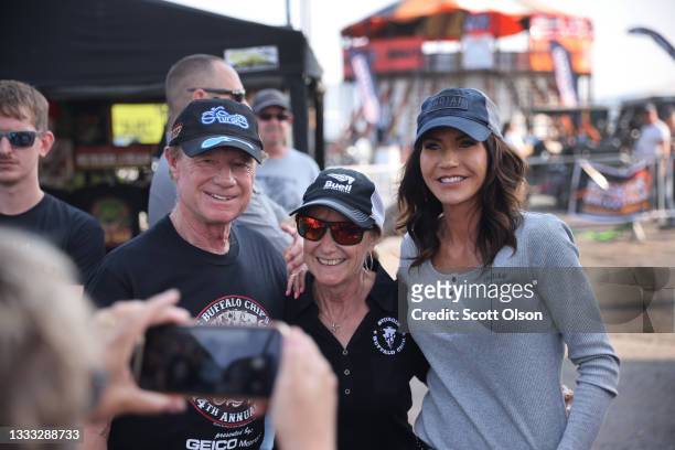 Governor Kristi Noem of South Dakota poses for pictures at the Sturgis Buffalo Chip campground after riding in the Legends Ride for charity on August...