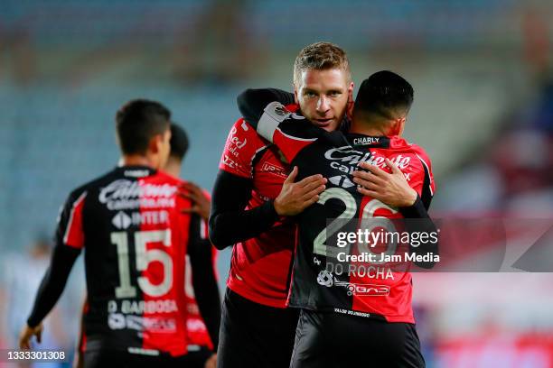 Julio Cesar Furch of Atlas celebrates with Aldo Paul Rocha after scoring his team's first goal during the 3rd round match between Pachuca and Atlas...