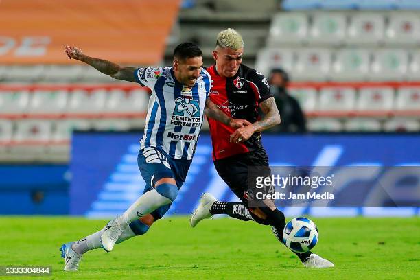 Victor Ismael Sosa of Pachuca fights for the ball with Luis Ricardo Reyes of Atlas during the 3rd round match between Pachuca and Atlas as part of...