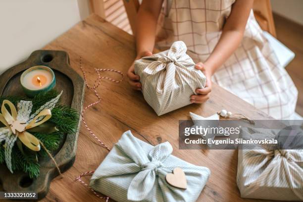 christmas furoshiki wrapping. zero waste concept. - pastel christmas stock pictures, royalty-free photos & images