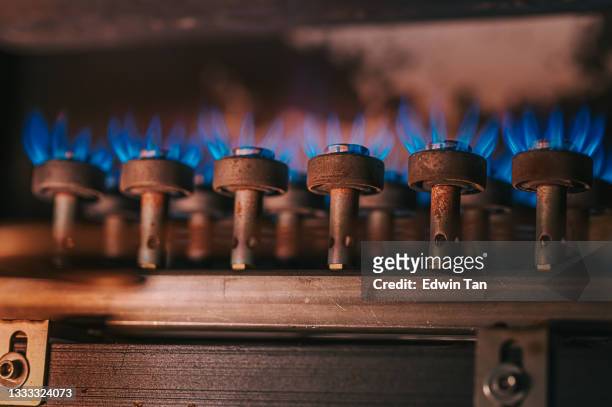 fire on gas stove with dark background - gas cooking stock pictures, royalty-free photos & images