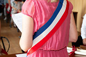 French blonde woman mayor with scarf france flag tricolor and girl pink dress during official celebration in city hall France