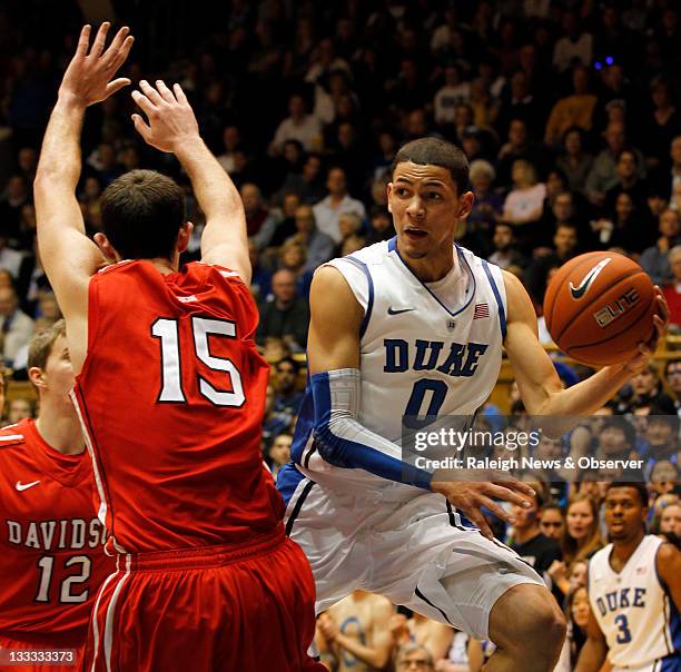 Duke guard Austin Rivers looks for help as Davidson forward Jake Cohen defends during the first half at Cameron Indoor Stadium in Durham, North...