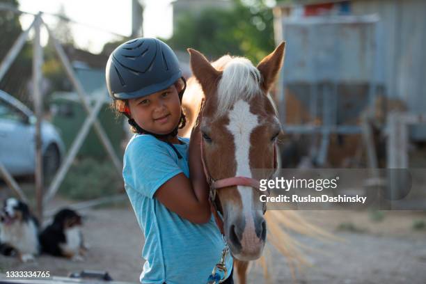 girl with horse. - children only stock pictures, royalty-free photos & images