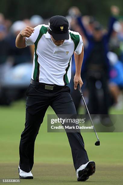 Ryo Ishikawa of the International Team celebrates making a putt on the 17th hole during the Day Three Morning Foursome Matches of the 2011 Presidents...