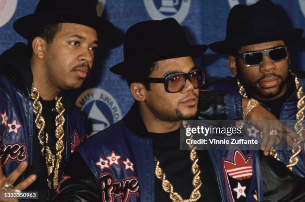 American hip hop group Run-DMC , wearing matching black-and-blue leather jackets with the Adidas logo, attend 30th Annual Grammy Awards, held at...