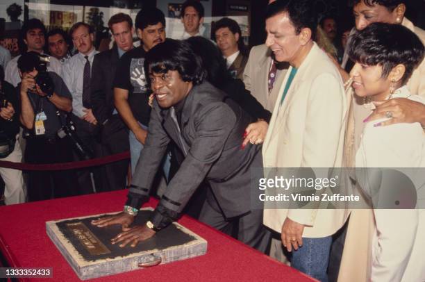 American singer, songwriter and musician James Brown creating his handprints during his ceremony at Hollywood's RockWalk on Vine Street in Los...