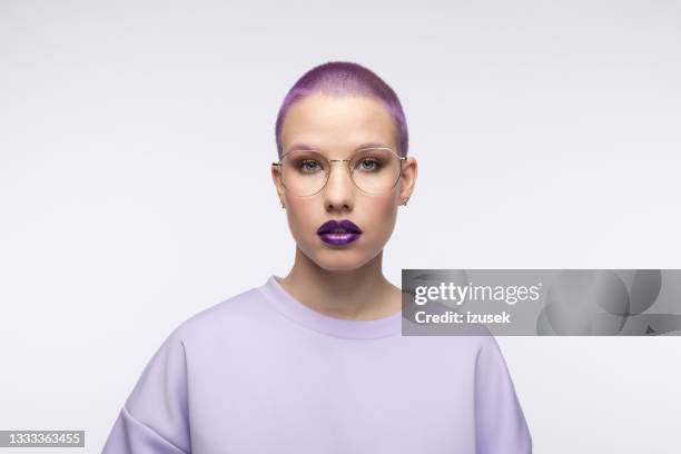 headshot of young woman with short purple hair - purple blouse stock pictures, royalty-free photos & images