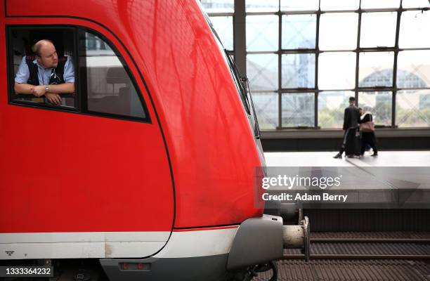 Regional train driver looks out of his window at Berlin's main train station, or Hauptbahnhof, on August 10, 2021 in Berlin, Germany. Ninety-five...