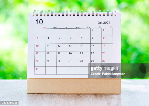 calendar desk 2021 october month for organizer to plan and reminder on wooden table with nature background. - united nations day stock pictures, royalty-free photos & images