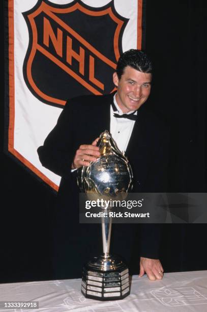Mario Lemieux, Captain and Center for the Pittsburgh Penguins poses with the Hart Memorial Trophy for the most valuable player of the National Hockey...