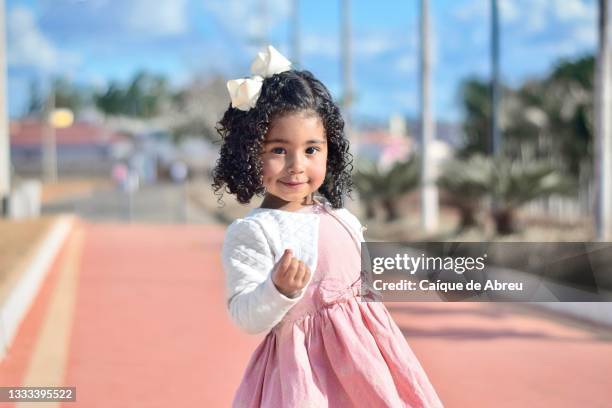 portrait of a little girl at a park - girls dress stock pictures, royalty-free photos & images