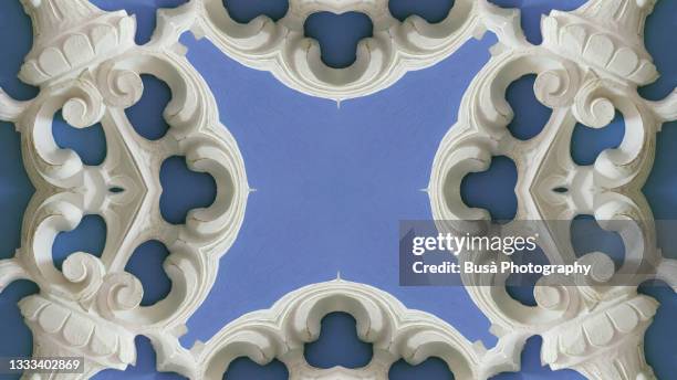 kaleidoscopic image of wooden baroque wall ornament against pastel colored background - bas reliëf stockfoto's en -beelden