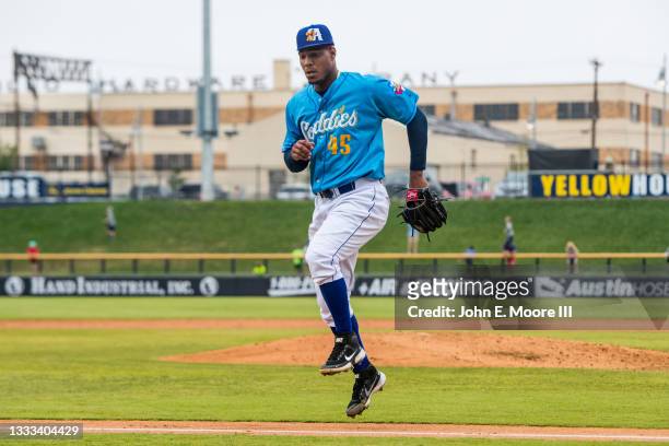 Pitcher Luis Frias of the Amarillo Sod Poodles jumps over the foul line during the first game of a double-header against the San Antonio Missions at...