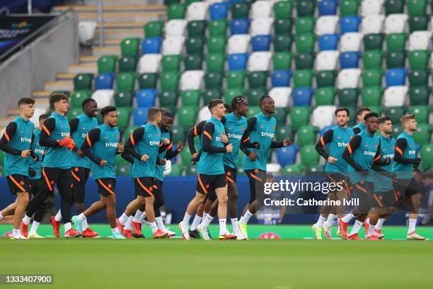 Chelsea players run on during a Chelsea FC Training Session ahead of the UEFA Super Cup 2021 match between Chelsea FC and Villarreal at Windsor Park...