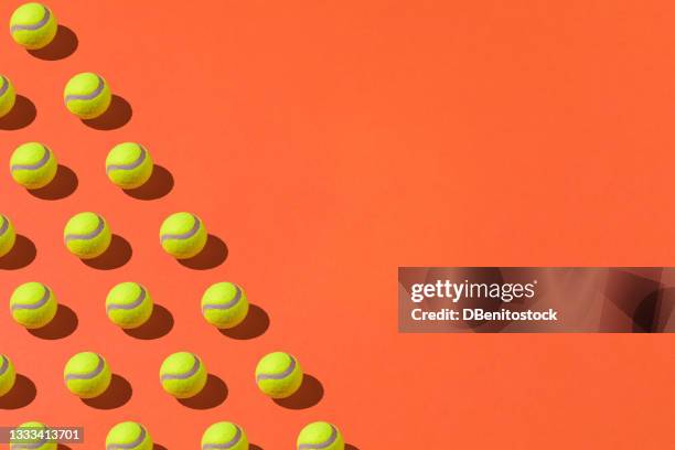 yellow tennis balls pattern with hard shadow on orange background. sport and tennis concept - abstract tennis player stock pictures, royalty-free photos & images