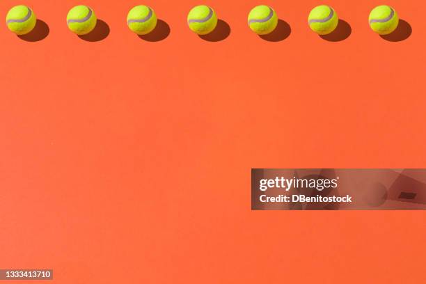 yellow tennis balls pattern with hard shadow on top line on orange background. sport and tennis concept - abstract tennis player stock pictures, royalty-free photos & images