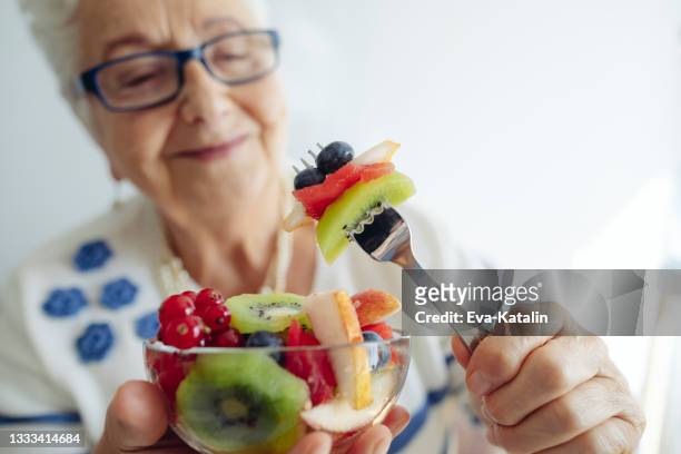 senior woman at home - healthy eating seniors stock pictures, royalty-free photos & images