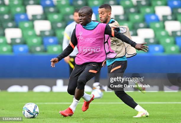 Golo Kante of Chelsea is challenged by Hakim Ziyech of Chelsea during a Chelsea FC Training Session ahead of the UEFA Super Cup 2021 match between...